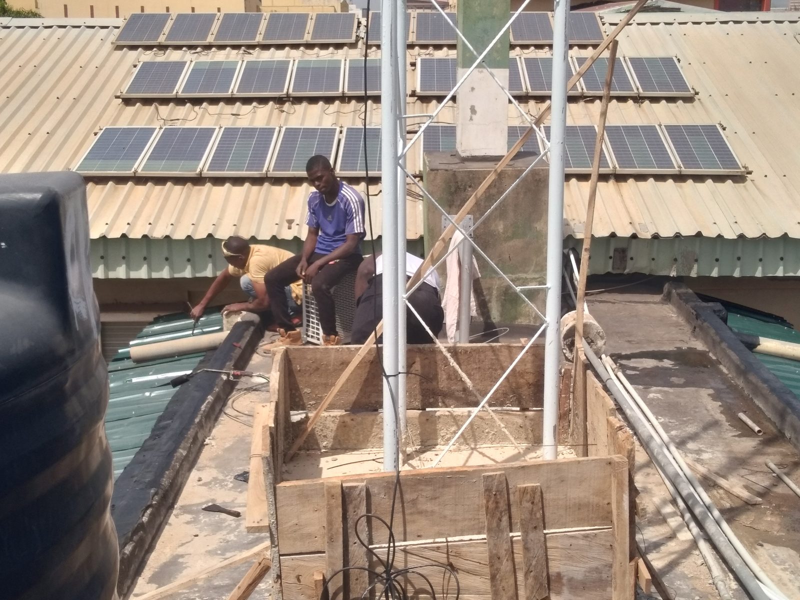 AIITIS field infrastructure &mdash; rooftop solar array and communication mast installation